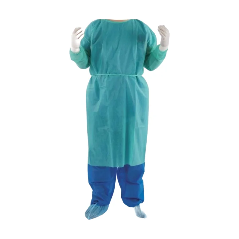 Green PP spunbond non-woven isolation gown with elastic cuffs and a waist tie, worn over blue trousers and shoe covers