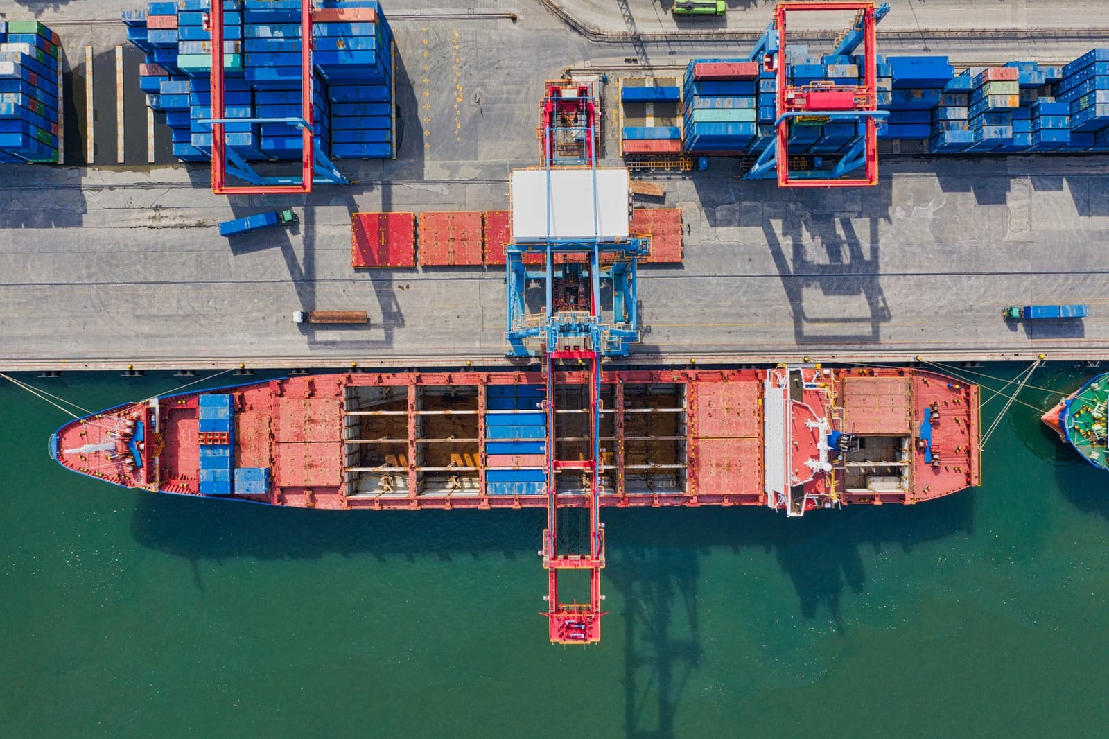 Aerial view of a container terminal with a cargo ship berthed