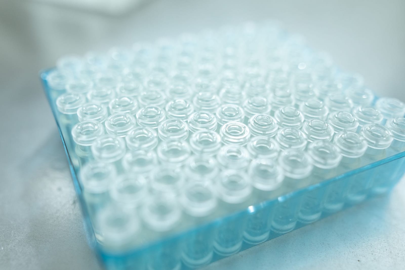 Tray of empty glass vials on a laboratory bench